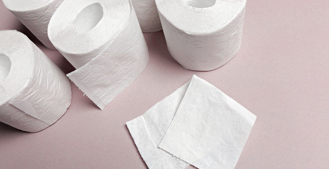 Toilet paper on pink background