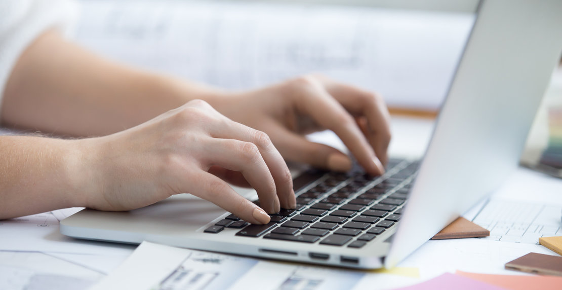 Typing on laptop, close-up