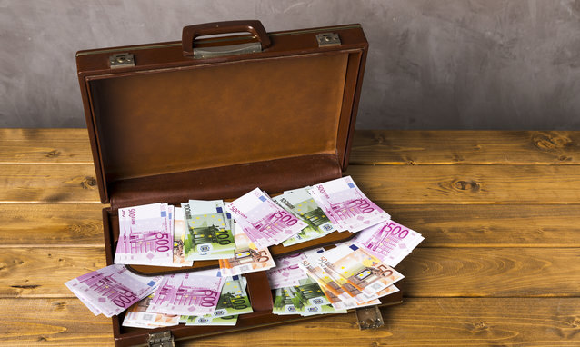 high angle opened suitcase with money