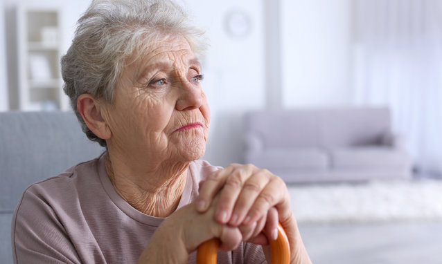 Elderly,Woman,With,Walking,Stick,At,Home